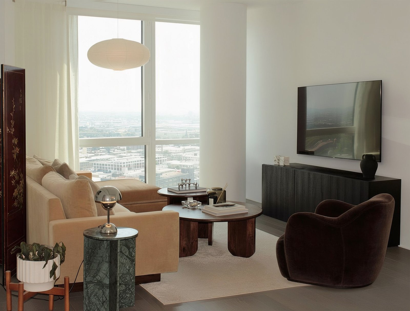 Sunlit living room with a camel velvet sofa